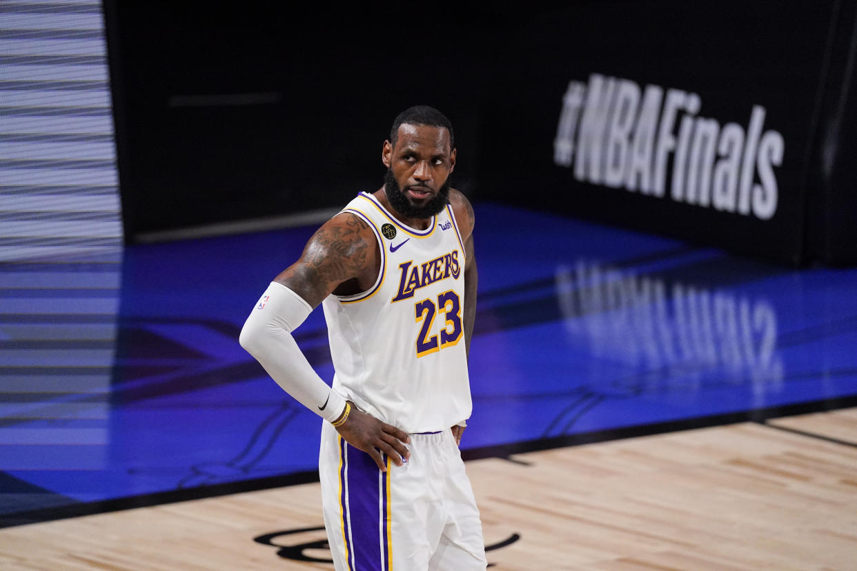 Los Angeles Lakers' LeBron James (23) looks on during the first half in Game 3 of basketball's NBA Finals against the Miami Heat, Sunday, Oct. 4, 2020, in Lake Buena Vista, Fla. (AP Photo/Mark J. Terrill)