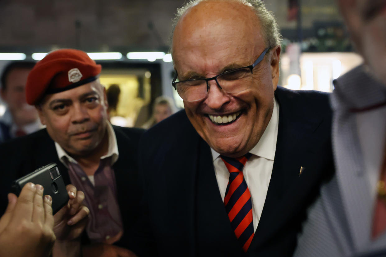 Rudy Giuliani smiles at an election night watch party for son Andrew.