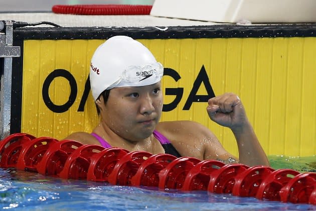 Singapore's Tao Li competes on the way to winning the women's 100-meter butterfly race during the 27th Southeast Asian Games in Naypyitaw, Myanmar, Saturday, Dec 14, 2013. (AP Photo/Vincent Thian)