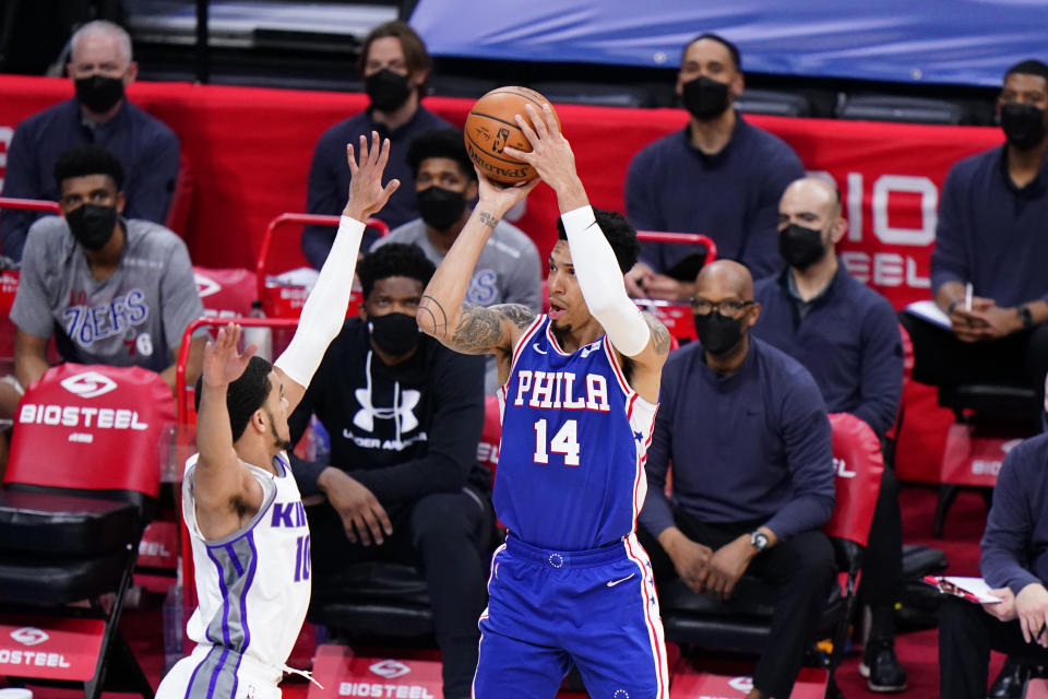 Philadelphia 76ers' Danny Green (14) goes up for a shot against Sacramento Kings' Justin James (10) during the first half of an NBA basketball game, Saturday, March 20, 2021, in Philadelphia. (AP Photo/Matt Slocum)