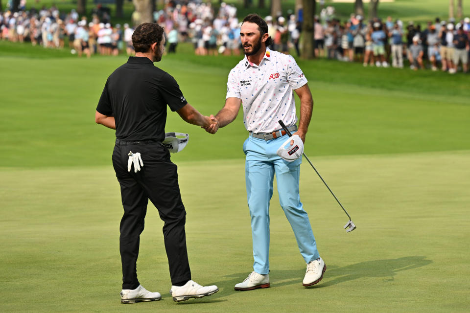 Patrick Cantlay, left and Max Homa shake hands after their round during the second round of the BMW Championship golf tournament. Mandatory Credit: Jamie Sabau-USA TODAY Sports