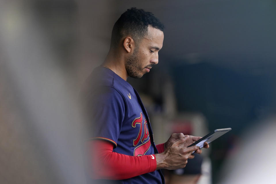 Minnesota Twins shortstop Carlos Correa reviews a play in the dugout during the bottom of the first inning of a baseball game against the Detroit Tigers in Minneapolis, Monday, Aug. 1, 2022. (AP Photo/Abbie Parr)