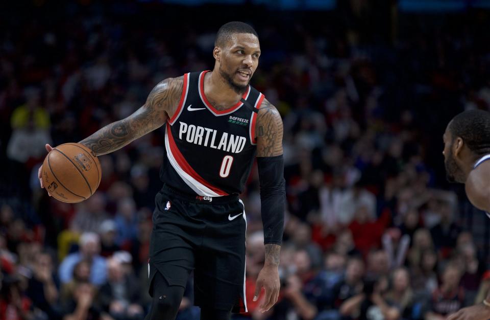 Portland Trail Blazers guard Damian Lillard brings the ball up the court against the Golden State Warriors during the second half of an NBA basketball game in Portland, Ore., Monday, Jan. 20, 2020. The Trail Blazers won 129-124 in overtime. (AP Photo/Craig Mitchelldyer)