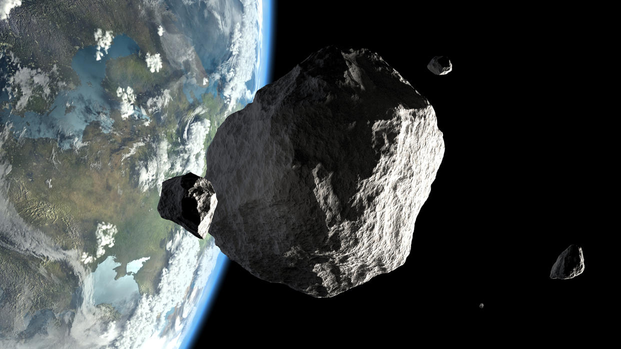  An artist's concept shows asteroids orbiting close to Earth. 