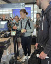 New York Liberty basketball player Sabrina Ionescu, center, waits to go through the security line with the team's manager of basketball operations Micaela Reese behind her at Bradley Airport in Hartford, Conn., Wednesday, June 25, 2023. WNBA players fly commercially between games unless they are playing back-to-back when they are allowed to fly charters to get to the second game. (AP Photo/Doug Feinberg)