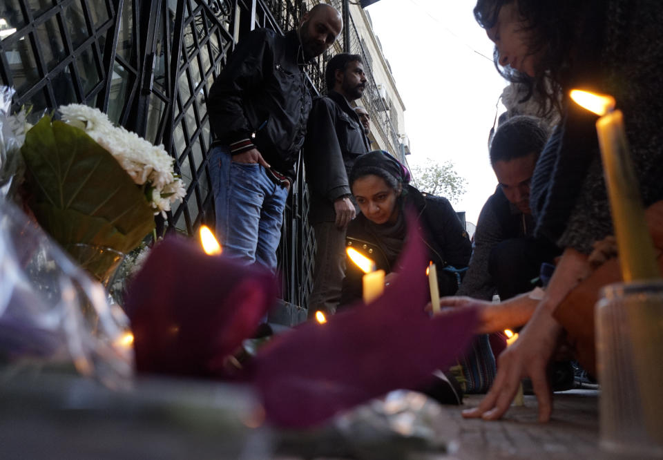 FILE - In this Feb. 6, 2016 file photo mourners light candles and lay wreaths in memory of slain Italian graduate student Giulio Regeni, in front of the Italian embassy in Cairo, Egypt. Italian prosecutors on Thursday, Dec. 10, 2020 formally put three high-ranking members of Egypt’s national security force and one police officer under investigation in the 2016 kidnapping, torture and killing of an Italian youth doing doctoral research in Cairo. (AP Photo/Amr Nabil, file)