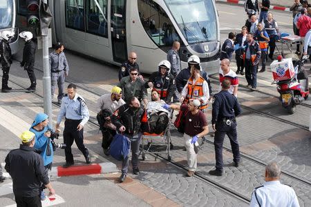 Israeli medics and emergency personnel evacuate a wounded Israeli from the scene of a stabbing in Pisgat Zeev, which lies on occupied land that Israel annexed to Jerusalem after the 1967 Middle East war, November 10, 2015. REUTERS/Ammar Awad