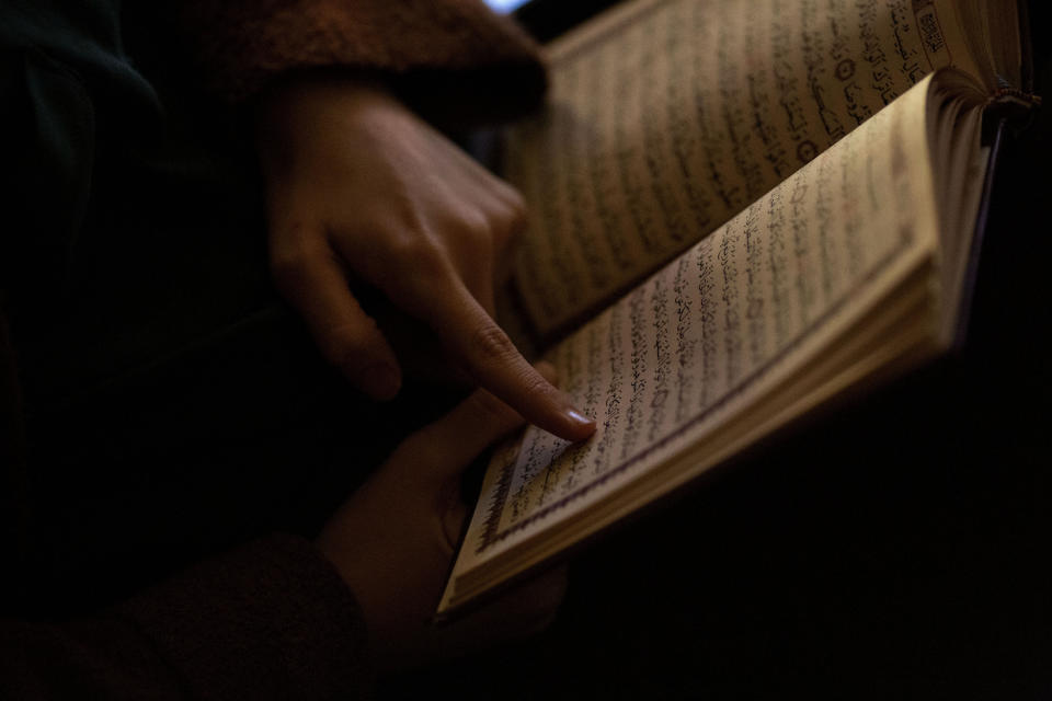 Dania Darwish, 27, director of the Asiyah Women's Center and a volunteer with Muslims Giving Back reads her Quran between volunteering at the Muslim Community Center in the Bay Ridge neighborhood of Brooklyn, New York, on Monday, April 27, 2020. (AP Photo/Wong Maye-E)