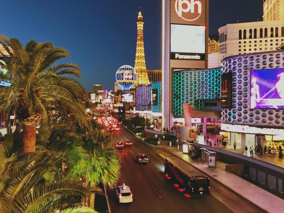 Las Vegas Strip at night with cars driving past