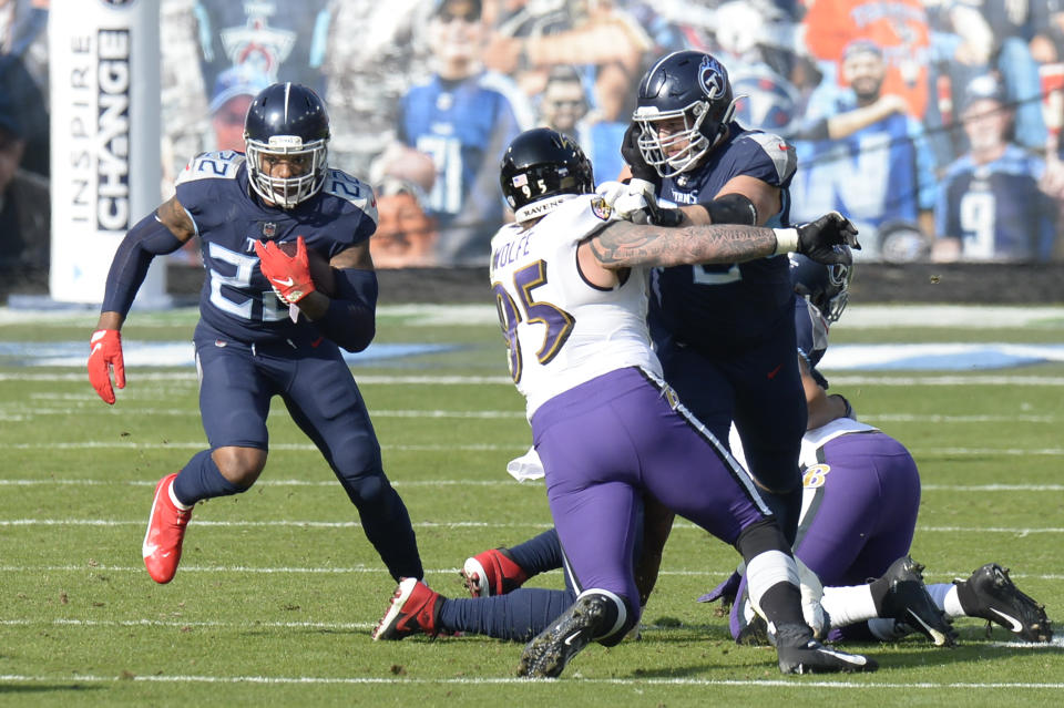 Tennessee Titans running back Derrick Henry (22) carries the ball past Baltimore Ravens defensive end Derek Wolfe (95) in the first half of an NFL wild-card playoff football game Sunday, Jan. 10, 2021, in Nashville, Tenn. (AP Photo/Mark Zaleski)