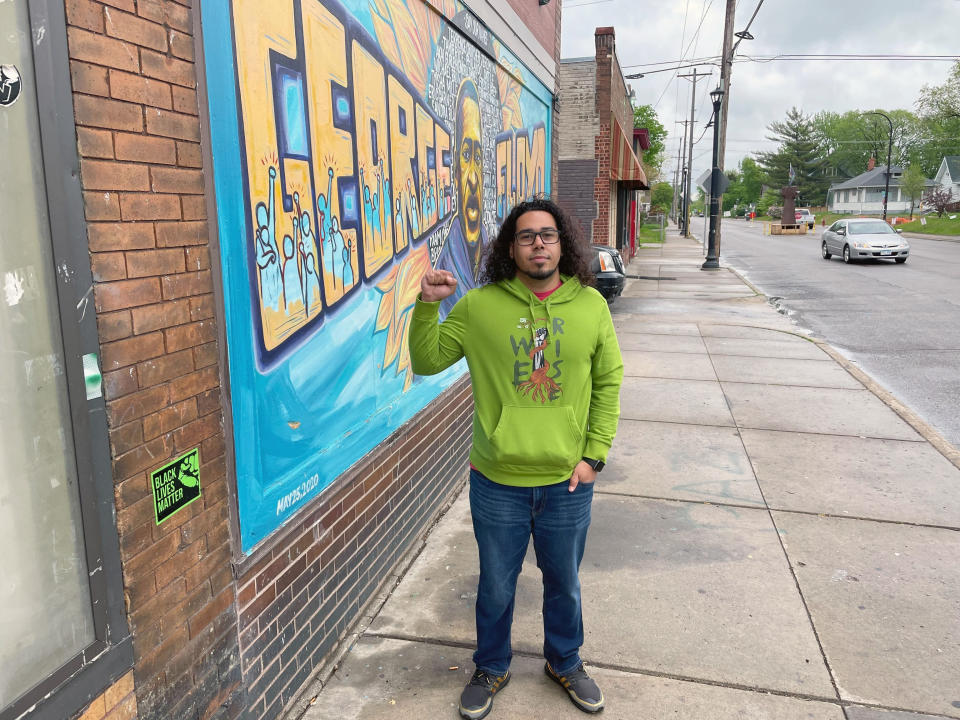 Colten Muth, 32, visits George Floyd Square in Minneapolis on Wednesday, May 25, 2022, to mark the second anniversary of the Black man's death at the hands of Minneapolis police officers. Muth said he went there to "make sure I'm paying homage because his sacrifice made a huge impact on the world." Muth, who identifies as mixed race, recalled watching the bystander video of Floyd's dying moments from his home in the Minneapolis suburb of Burnsville. He said it hit him especially hard because he grew up just blocks from the corner where Floyd was killed. (Mohamed Ibrahim/Report for America via AP)