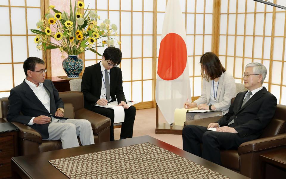 Japan's Foreign Minister Taro Kono, left, meets with South Korean Ambassador to Japan Nam Gwan Pyo, right, at foreign ministry in Tokyo Friday, July 19, 2019. Japan has summoned South Korea's ambassador to protest Seoul's refusal to join in an arbitration panel to settle a dispute over World War II labor. (Masanobu Kumagai/Kyodo News via AP)