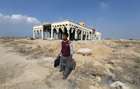 Palestinian songbird catcher Hamza Abu Shalhoub, 16, walks at the site of Gaza destroyed airport, in Rafah in the southern Gaza Strip November 8, 2018. Picture taken November 8, 2018. REUTERS/Ibraheem Abu Mustafa