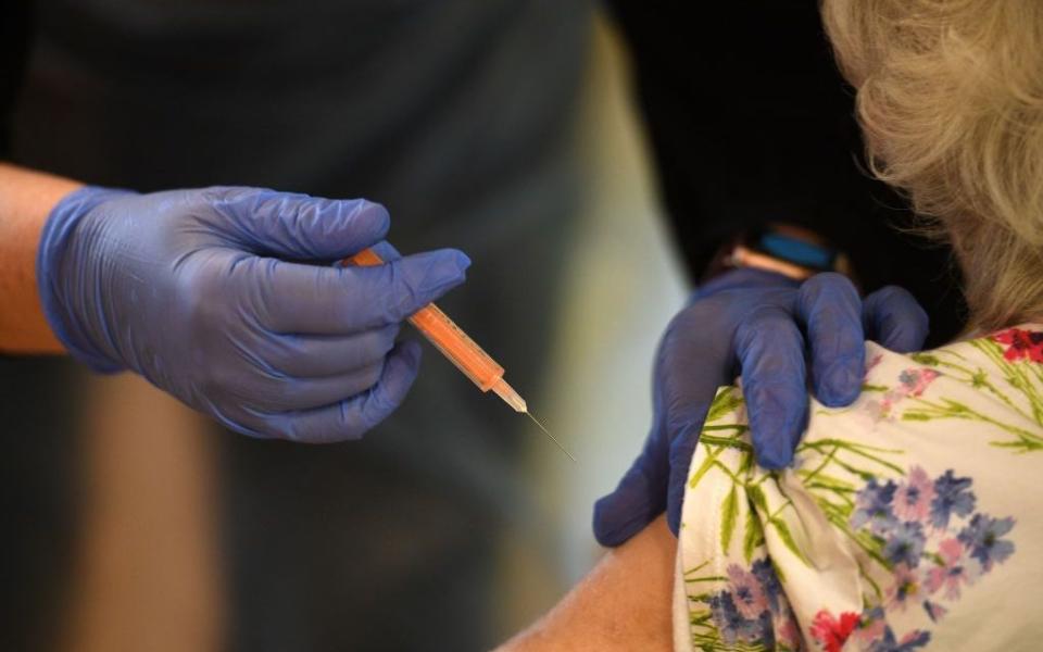 An older woman receives a vaccine - Getty