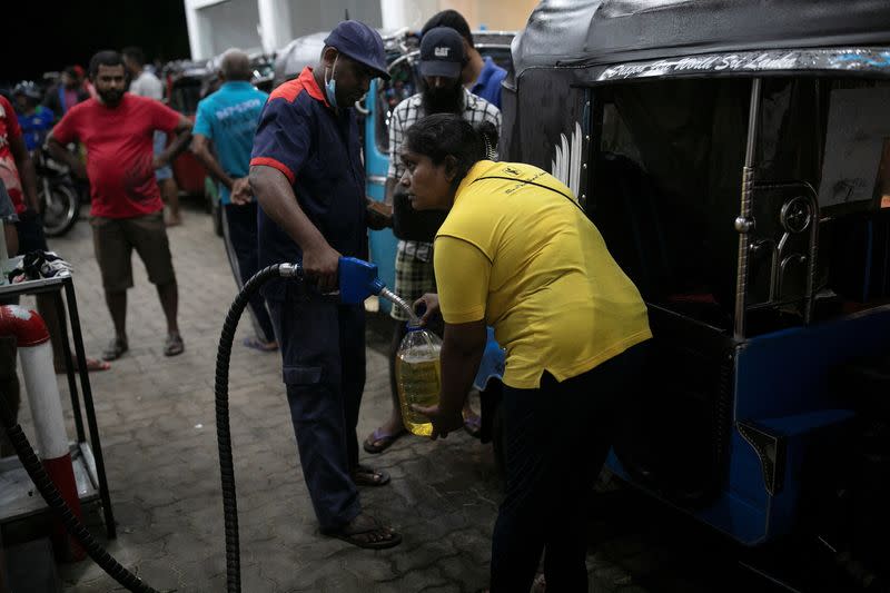 The Wider Image: Sri Lankan woman rickshaw driver has to queue 12 hours, or more, for fuel