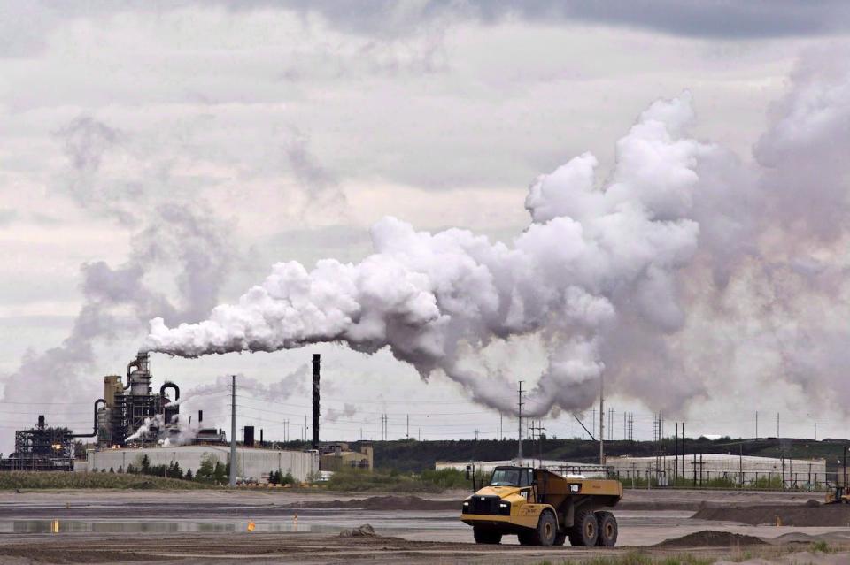 A dump truck works near the Syncrude oil sands extraction facility near the city of Fort McMurray, Alta., on June 1, 2014. A treaty signed by more than 50 aboriginal groups who oppose oilsands project and pipeline developments is based on misinformation, says a northern Alberta chief whose First Nation does extensive business with oilsands companies. 