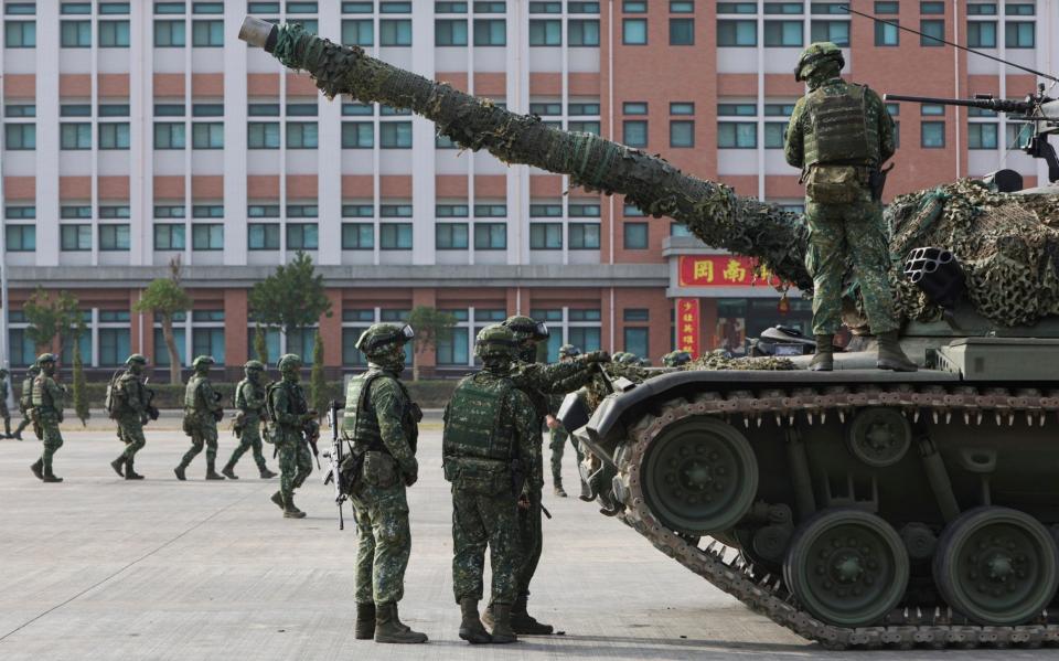 Soldiers and tanks are deployed to a preparedness enhancement drill simulating the defense against Beijing's military intrusions, ahead of the Lunar New Year in Kaohsiung City, Taiwan on Wednesday, Jan 11, 2023. China renewed its threats Wednesday to attack Taiwan and warned that foreign politicians who interact with the self-governing island are &quot;playing with fire.&quot; - Daniel Ceng/AP