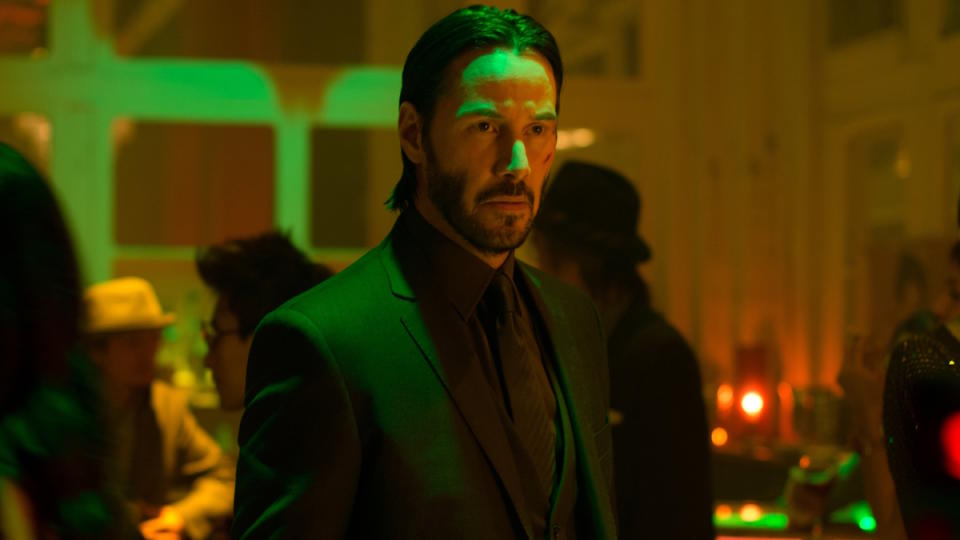 Keanu Reeves stands in a nightclub in John Wick: Chapter 2