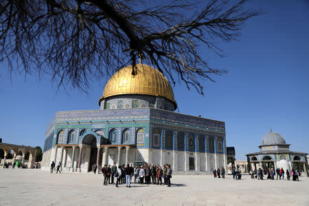 Tourists take part in the Dual Narrative tour lead by tour guides, Noor Awad, a Palestinian from Bethlehem, and Lana Zilberman Soloway, a Jewish seminary student, stand next to the Dome of the Rock on the compound known to Jews as Temple Mount and to Muslims as The Noble Sanctuary, in Jerusalem's Old City, February 4, 2019. REUTERS/Ammar Awad/Files