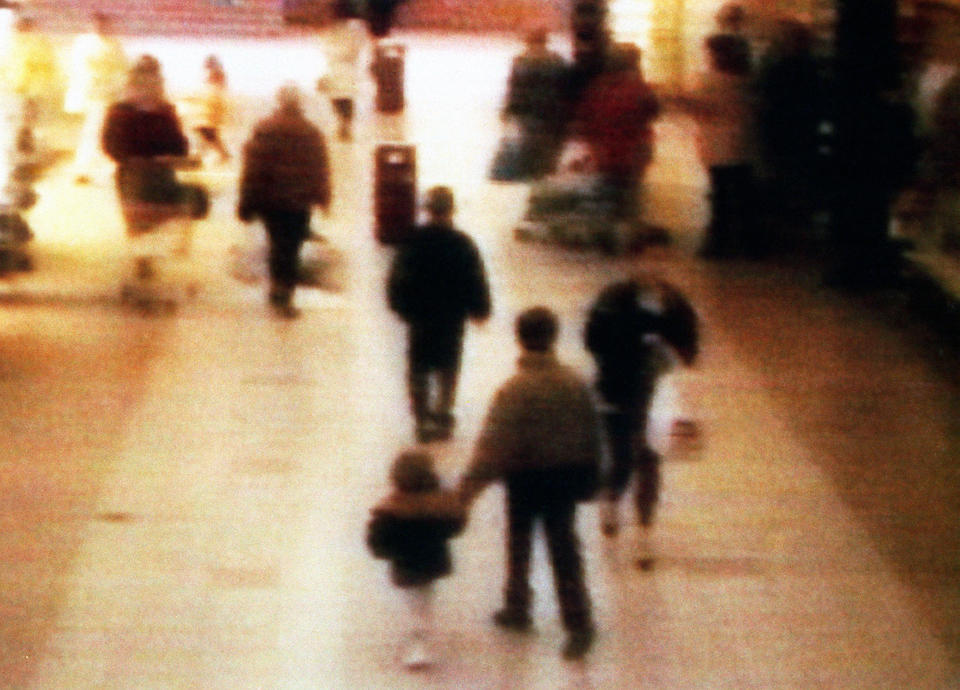 Chilling: A video still of missing boy James Bulger, aged 2 years old, being led away in the 'New Strand' shopping centre in the Bootle area of Liverpool, before he was tortured and killed. (PA)