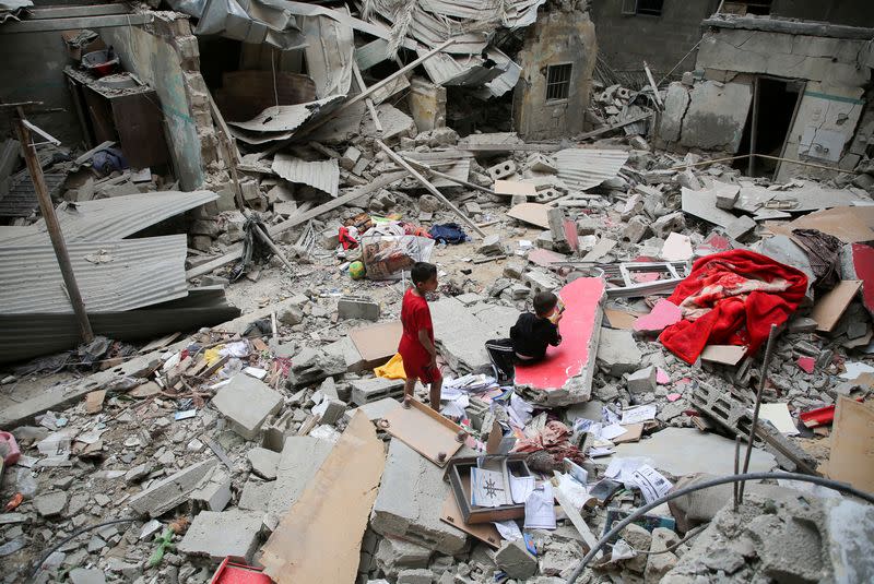 FILE PHOTO: Palestinian children inspect the site of an Israeli strike on a house, in Rafah