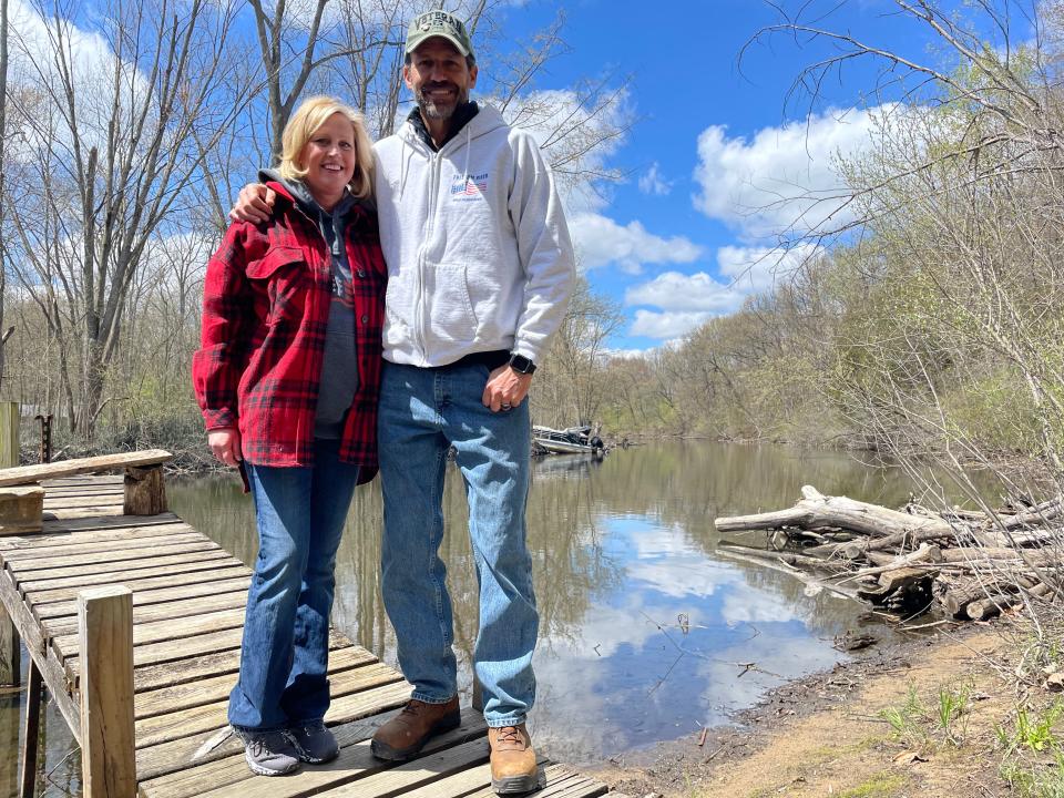 Janna and Jeff Yeakey stand on a dock over the Huron River on property they purchased for Freedom River in Hamburg Township.