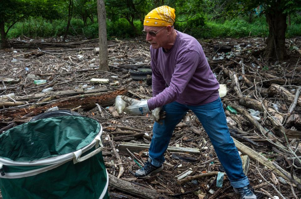 John Judy, from Westhampton, volunteers with Spearhead Project Earth during their weekly cleanup of Burlington Island on the Delaware River in between New Jersey and Pennsylvania on Thursday, Aug. 10, 2023.