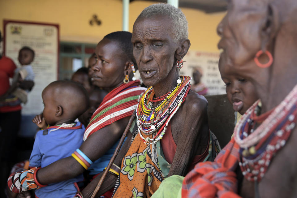 Women and malnourished children wait at a dispensary in Samburu County, Kenya, on Thursday, Oct. 13, 2022. Droughts in the region are worsening due to climate change, making it harder for people to get access to water. (AP Photo/Brian Inganga)