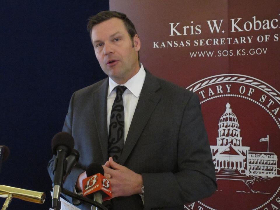 Kansas Secretary of State Kris Kobach answers questions from reporters during a news conference about a federal judge's ruling ordering the federal government to help Kansas and Arizona enforce their proof-of-citizenship requirements for new voters, Wednesday, March 19, 2014, in Topeka, Kan. Kobach and Arizona Secretary of State Ken Bennett filed a lawsuit over the issue. (AP Photo/John Hanna)