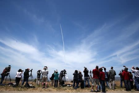 People watch as the Ground-based Midcourse Defense (GMD) element of the U.S. ballistic missile defense system launches during a flight test from Vandenberg Air Force Base, California, U.S., May 30, 2017. REUTERS/Lucy Nicholson