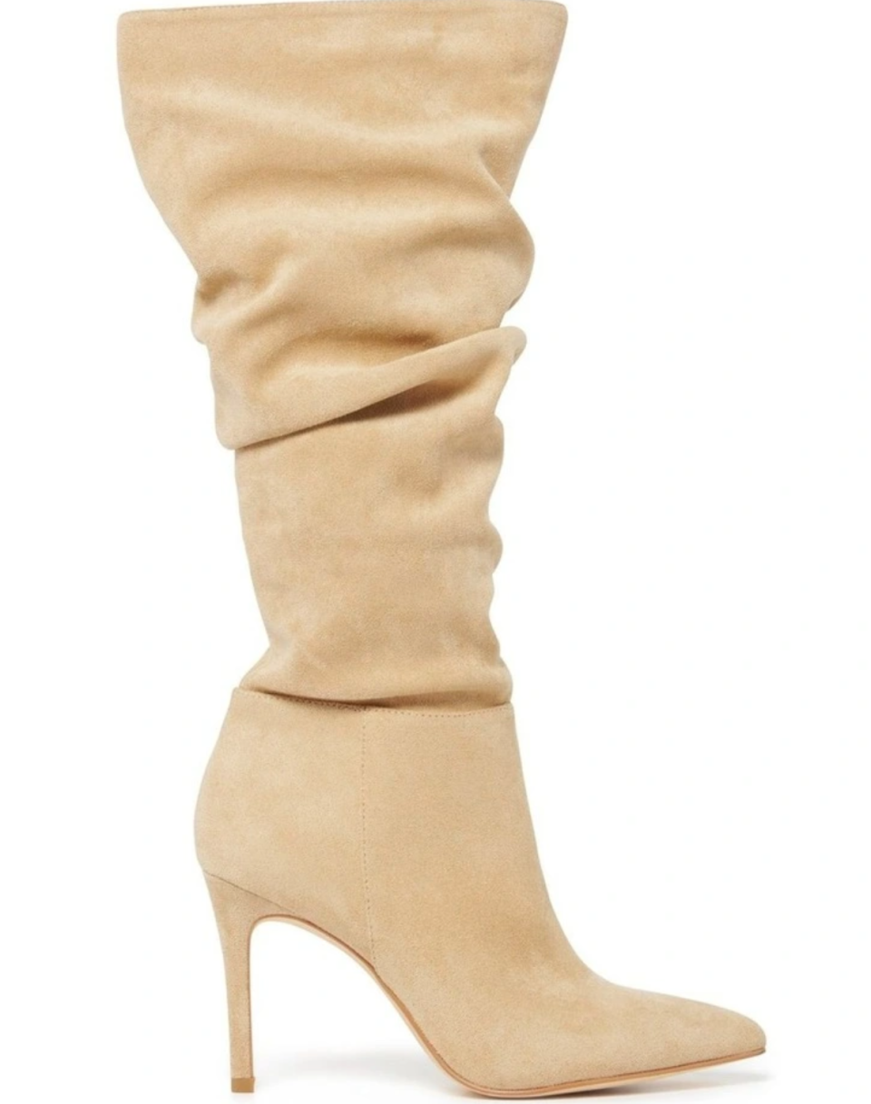 A loose cream knee-high boot with high stiletto heel shown against a white background.