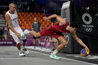 Belgium's Rafael Bogaerts, right, chases a loose ball as Latvia's Edgars Krumins (3) watches during a men's 3-on-3 basketball game at the 2020 Summer Olympics, Saturday, July 24, 2021, in Tokyo, Japan. (AP Photo/Jeff Roberson)