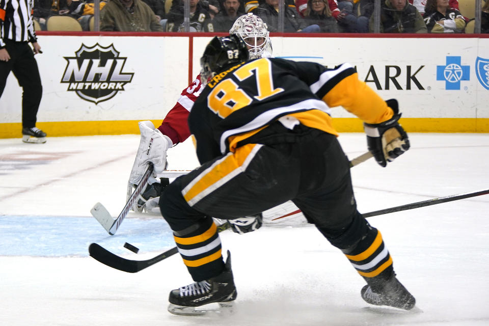 Pittsburgh Penguins' Sidney Crosby (87) shoots the puck past Detroit Red Wings goaltender Calvin Pickard (31) for a goal during the second period of an NHL hockey game in Pittsburgh, Sunday, March 27, 2022. (AP Photo/Gene J. Puskar)