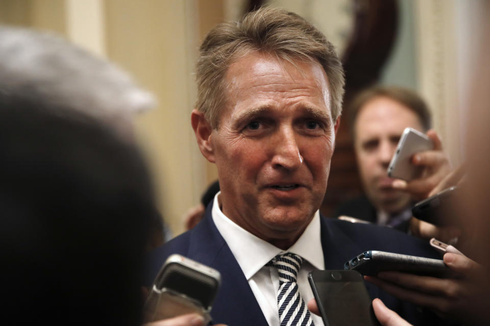 Sen. Jeff Flake, R- Ariz., is questioned by reporters about Supreme Court nominee Brett Kavanaugh, Friday Sept. 28, 2018, on Capitol Hill in Washington. After a flurry of last-minute negotiations, the Senate Judiciary Committee advanced Brett Kavanaugh's nomination for the Supreme Court after agreeing to a late call from Sen. Flake for a one week investigation into sexual assault allegation against the high court nominee. (AP Photo/Jacquelyn Martin)