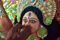 GUWAHATI, INDIA - OCTOBER 13, 2020: An artisan gives a final touches to an idol of the Goddess Durga ahead of the upcoming 'Durga Puja' festival in Guwahati ,India - PHOTOGRAPH BY Anuwar Ali Hazarika / Barcroft Studios / Future Publishing (Photo credit should read Anuwar Ali Hazarika/Barcroft Media via Getty Images)