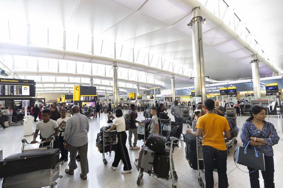 Queues form at Heathrow Airport.