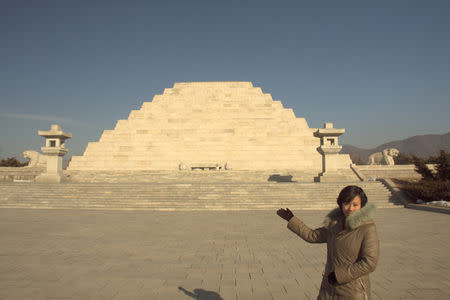 A tourist visits what North Korea says is the reconstructed tomb of King Dangun, the mythical founder of the first unified Korean kingdom in 2333 BCE, outside Pyongyang, North Korea in this undated handout photo. Koryo Tours/Handout via REUTERS