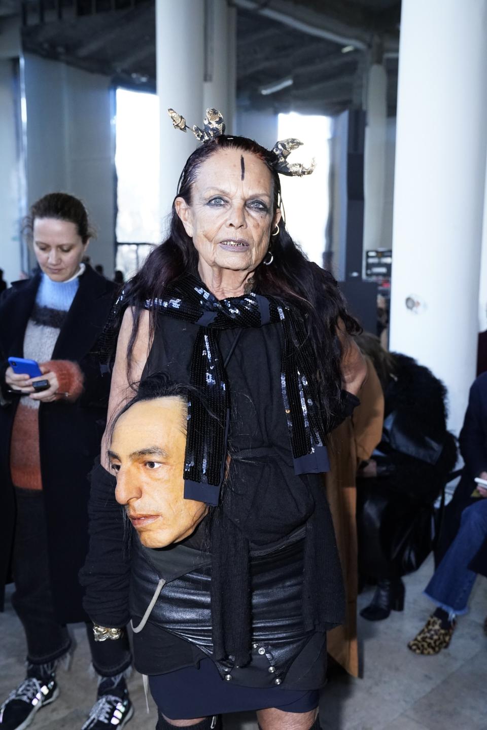 Totally weird and perfectly funny: Michèle Lamy at the Rick Owens show, carrying Rick Owens's head. Photo by Peter White/Getty Images.