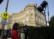 A television cameraman sets up outside the Cuban Interests Section is seen in Washington July 1, 2015. REUTERS/Gary Cameron