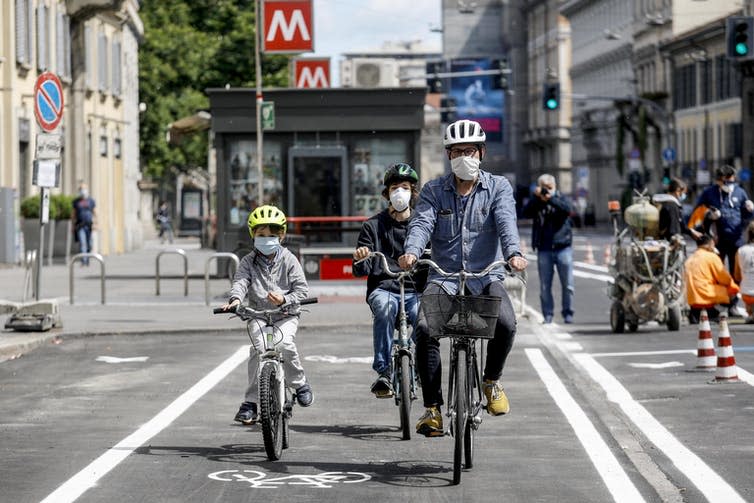 <span class="caption">A family travels on a new bike path opened during lockdown in Milan, Italy.</span> <span class="attribution"><a class="link " href="https://webgate.epa.eu/webgate" rel="nofollow noopener" target="_blank" data-ylk="slk:EPA-EFE/MOURAD BALTI TOUATI;elm:context_link;itc:0;sec:content-canvas">EPA-EFE/MOURAD BALTI TOUATI</a></span>