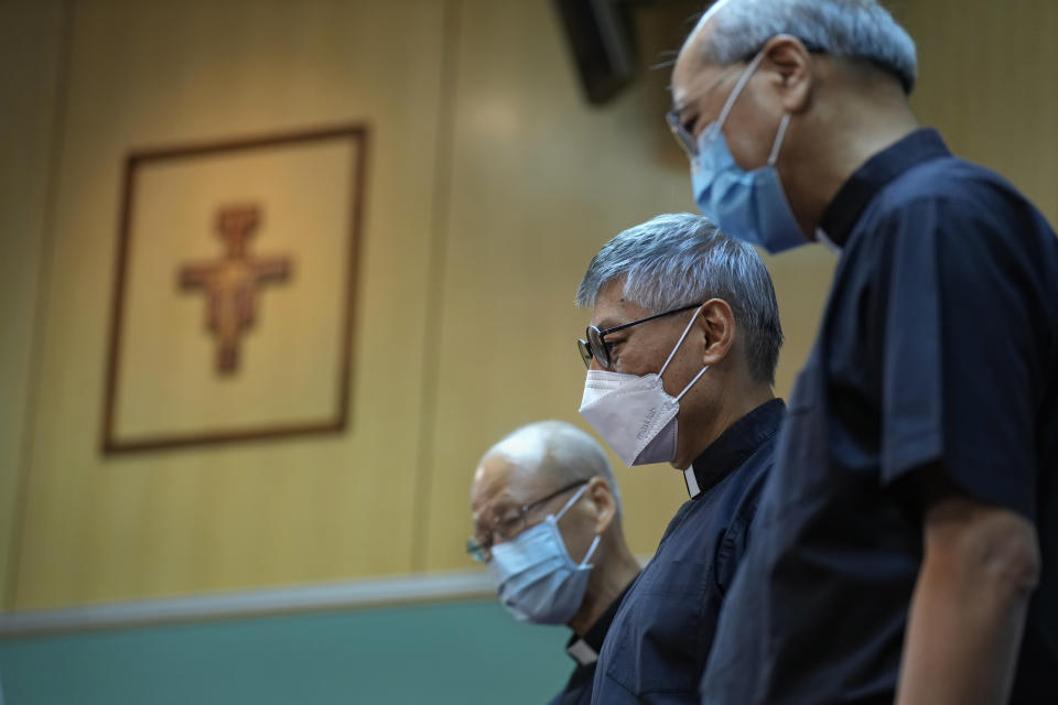 From left, Cardinal John Tong Hon, Stephen Chow Sau-yan and Bishop Joseph Ha Chi-Shing, OFM Auxiliary Bishop of Hong Kong pose for photographers after a press conference in Hong Kong Tuesday, May 18, 2021. Pope Francis on Monday named a new bishop for Hong Kong, tapping the head of his own Jesuit order in the region, the Rev. P. Stephen Chow Sau-Yan, for the politically sensitive position that has been vacant for two years. (AP Photo/Vincent Yu)