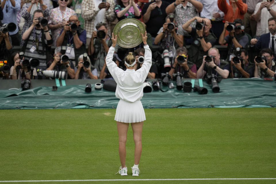 Czech Republic's Marketa Vondrousova celebrates with the trophy after beating Tunisia's Ons Jabeur to win the final of the women's singles on day thirteen of the Wimbledon tennis championships in London, Saturday, July 15, 2023. (AP Photo/Kirsty Wigglesworth)