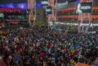 People gather around a makeshift memorial for former NBA and Los Angeles Lakers player Kobe Bryant after learning of his death, at LA Live plaza in front of Staples Center in Los Angeles on January 26, 2020.(Photo by Apu GOMES / AFP)