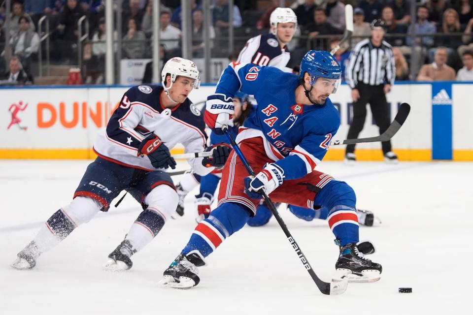 New York Rangers' Chris Kreider (20) drives past Columbus Blue Jackets' Yegor Chinakhov (59) during the first period of an NHL hockey game Wednesday, Feb. 28, 2024, in New York. (AP Photo/Frank Franklin II)