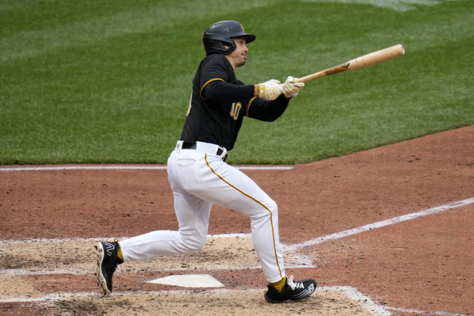 Pittsburgh Pirates' Bryan Reynolds triples, with the bases loaded, off Chicago White Sox relief pitcher Jimmy Lambert to drive in three runs during the fifth inning of the Pirates home opener baseball game in Pittsburgh, Friday, April 7, 2023. Reynolds then scored on an errant relay throw to third. (AP Photo/Gene J. Puskar)