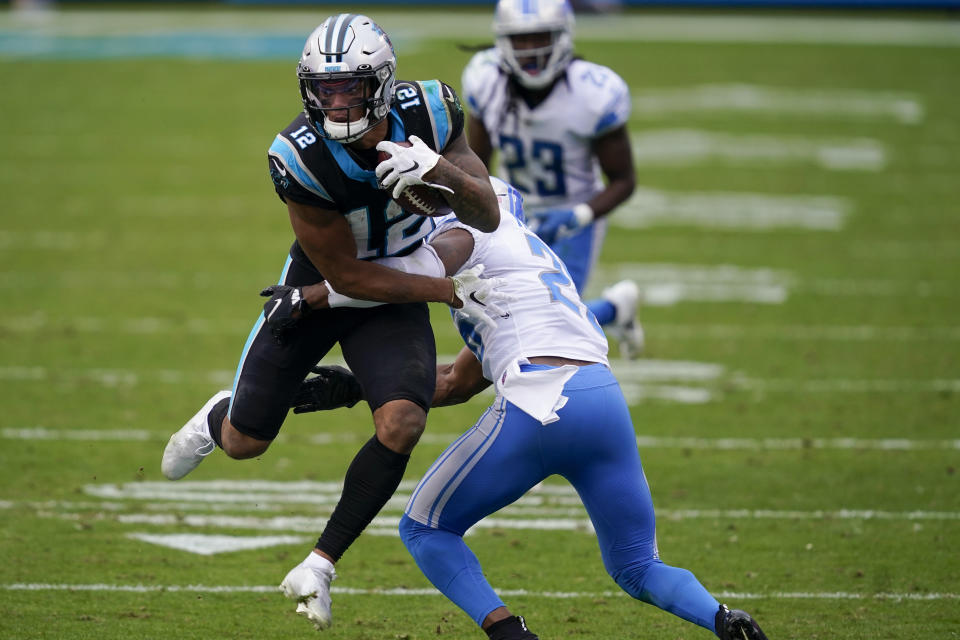 Carolina Panthers wide receiver D.J. Moore is tackled by Detroit Lions strong safety Duron Harmon during the second half of an NFL football game Sunday, Nov. 22, 2020, in Charlotte, N.C. (AP Photo/Gerry Broome)