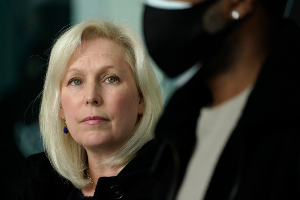 Sen. Kirsten Gillibrand listens as the N.Y. public advocate speaks during a news conference.