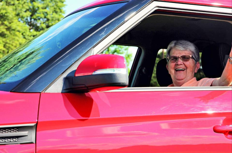 Johnette “Inky” Eckstine waves during a 2013 jaunt in her red Kia Soul.