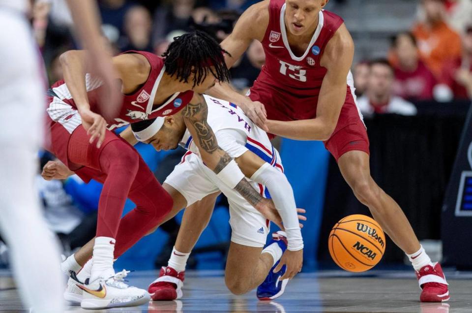 Kansas guard Dajuan Harris Jr. (3) fights for possession with Arkansas guard Nick Smith Jr. (3) during a second-round college basketball game in the NCAA Tournament Saturday, March 18, 2023, in Des Moines, Iowa.