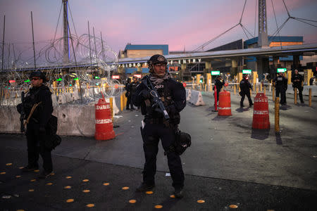 U.S. Customs and Border Protection (CBP) Special Response Team (SRT) officers stand guard at the San Ysidro Port of Entry after the land border crossing was temporarily closed to traffic from Tijuana, Mexico November 19, 2018. REUTERS/Adrees Latif